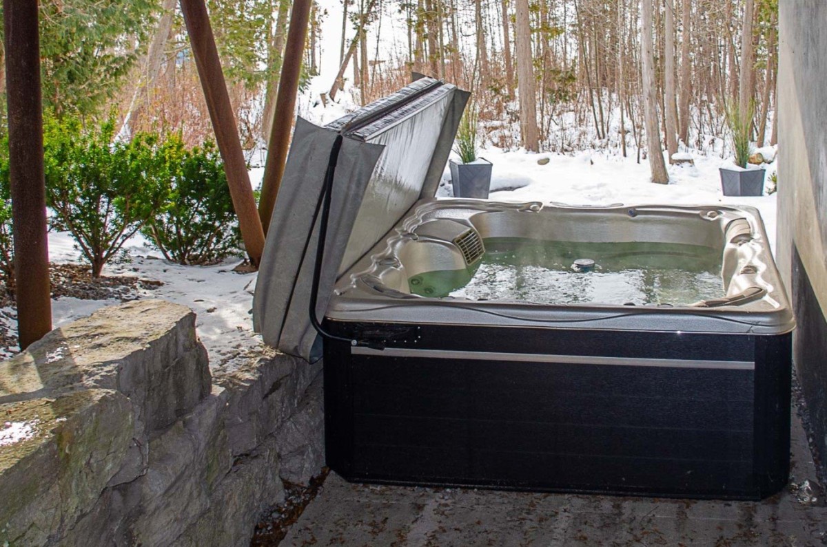 Covered hot tub overlooking lake