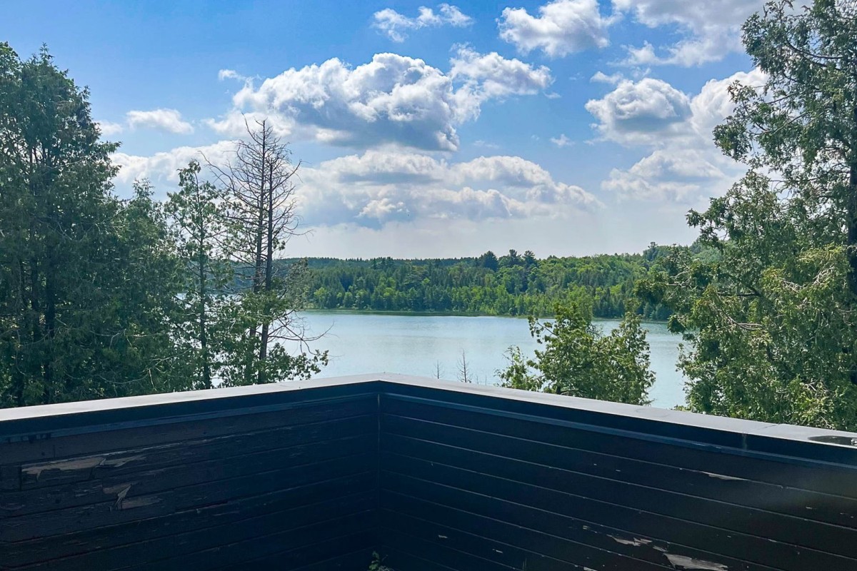 Rooftop patio view of the lake and and woodlands