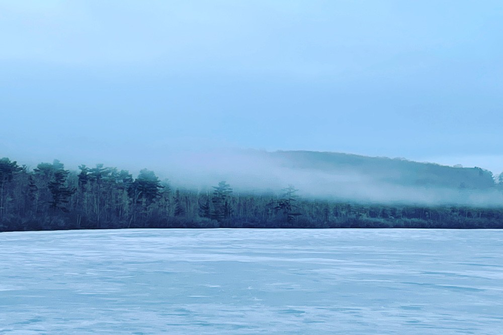 Misty Winter View over Frozen Lake