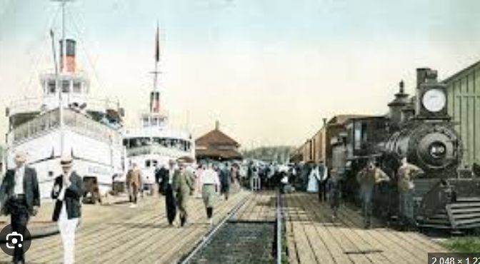 Historic picture of steamships moored at a railway station and people walking between - Gravenhurst, Muskoka